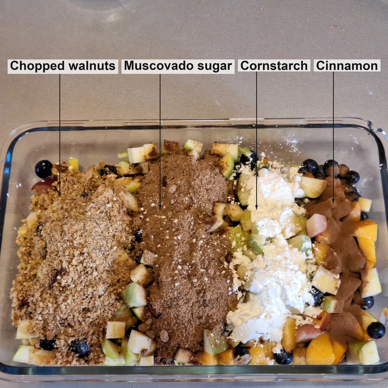 Chopped fruit with (from left to right) chopped walnuts, whole grain sugar, cornstarch, cinnamon.