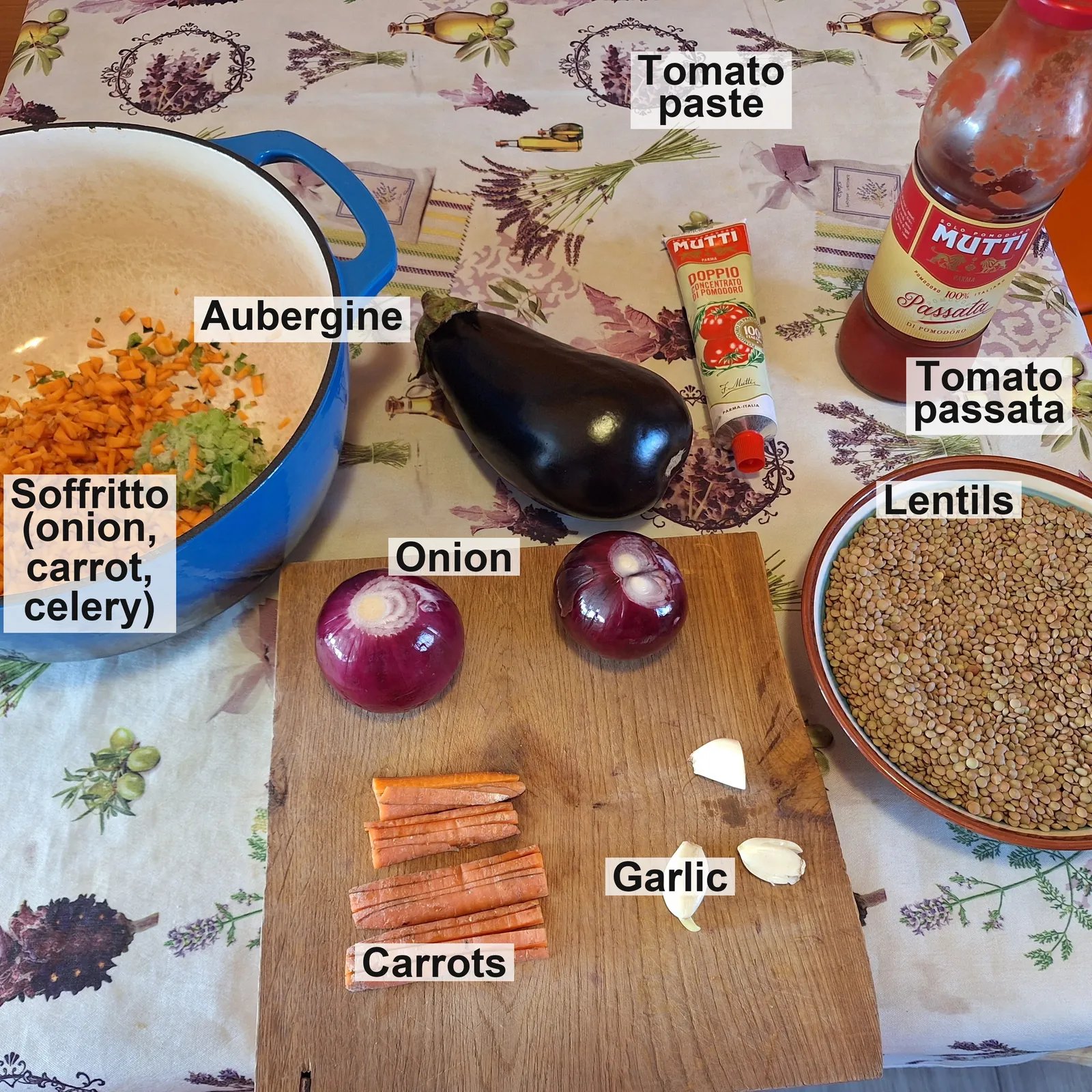 The labelled ingredients: the soffritto of onion, carrot and celery in the pot, aubergine, tomato paste, passata, onion, carrots, garlic and lentils.